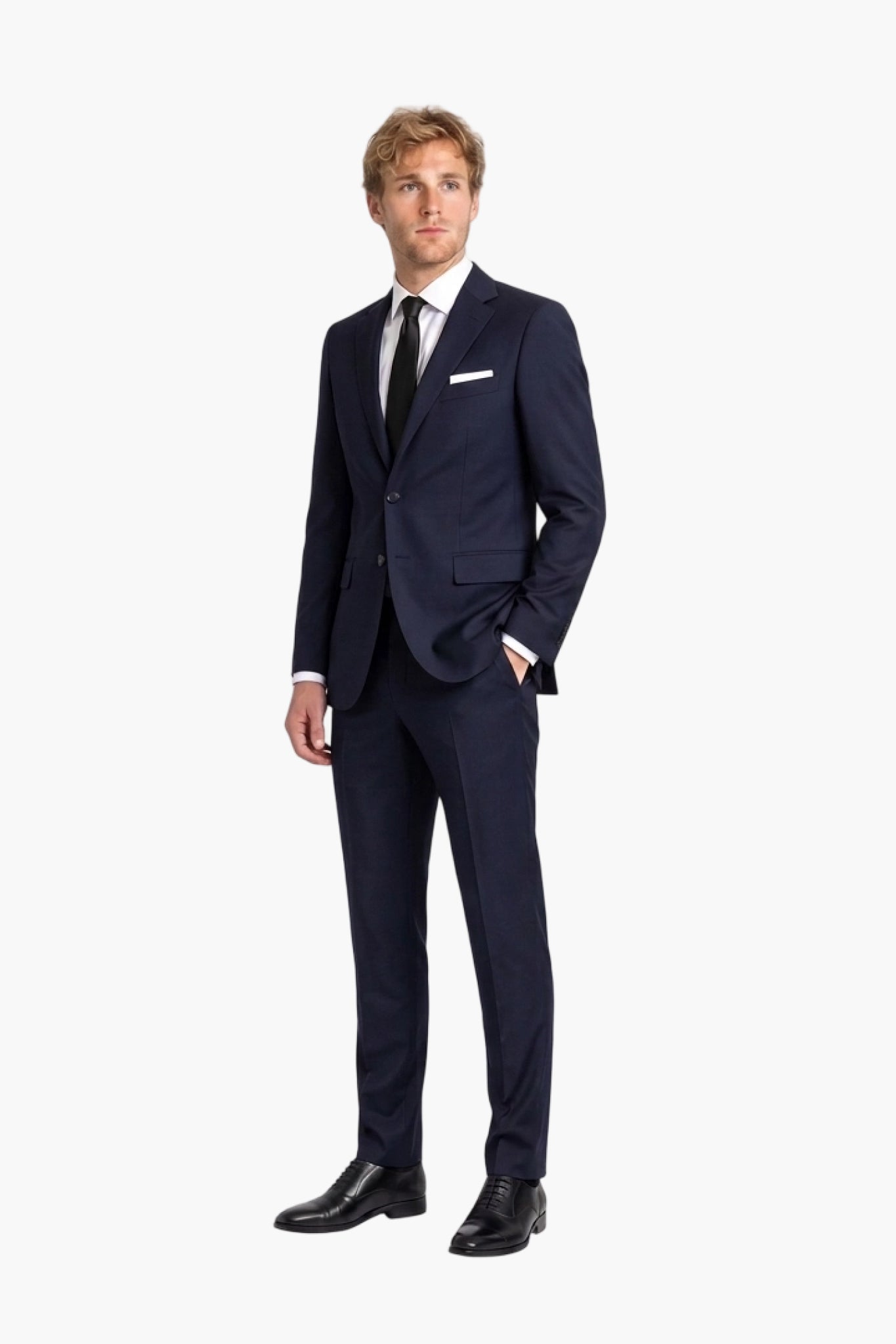 A man modeling a navy blue wool two-piece suit with a white dress shirt, black tie, and white pocket square, standing against a plain white background.
