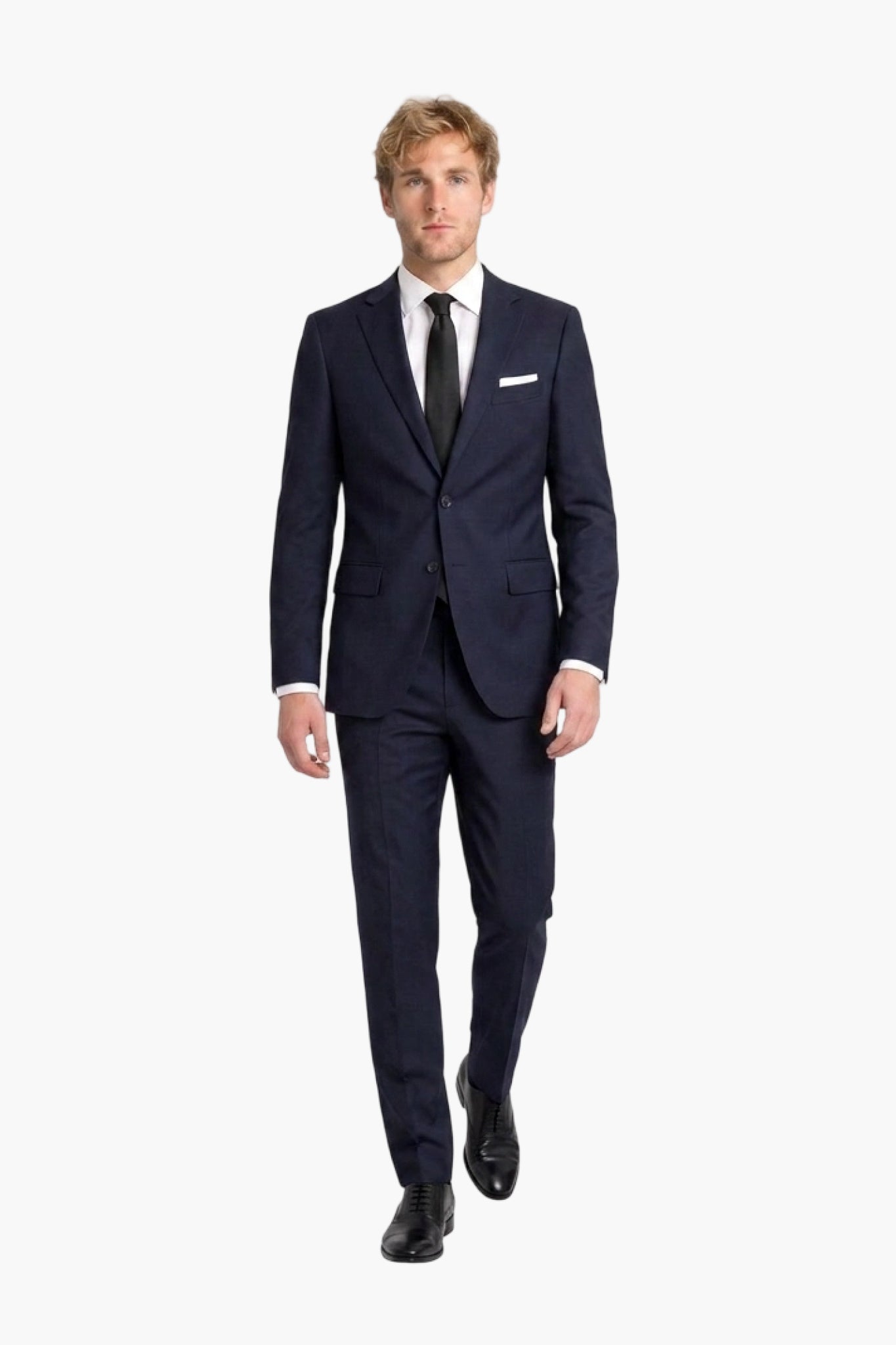 A man modeling a dark navy blue wool two-piece suit with a white dress shirt, black tie, and white pocket square, walking against a solid white background.
